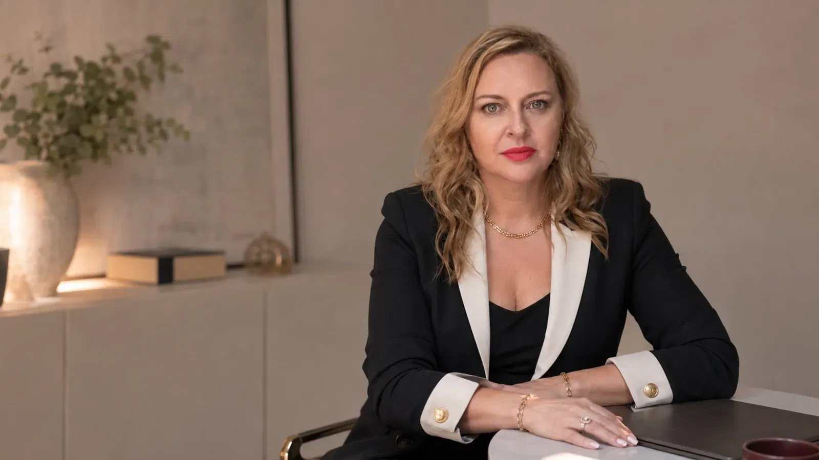 Andrea Florescu seated at desk representing execution partnership over passive consulting