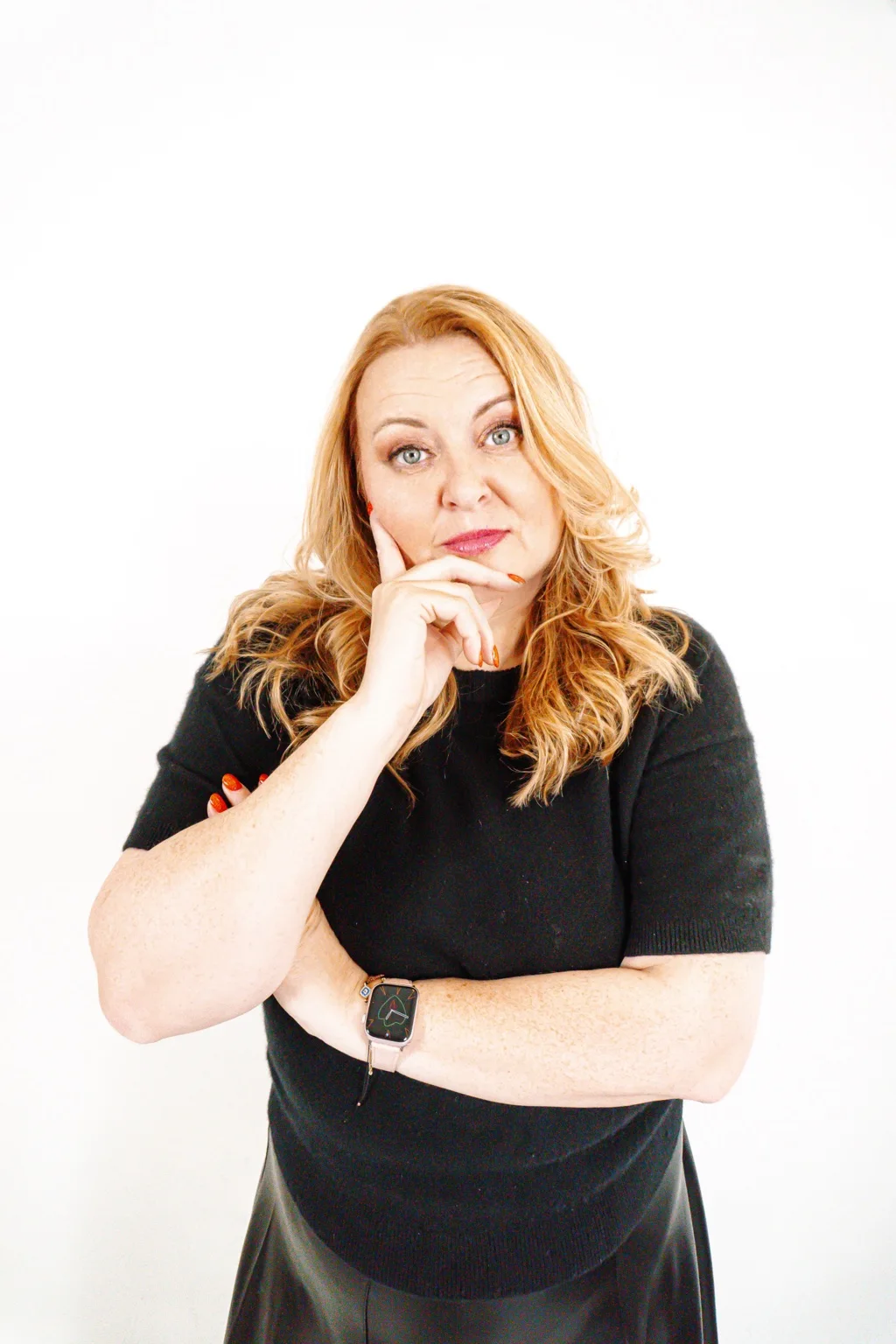 Andrea in black, confident and thoughtful studio portrait