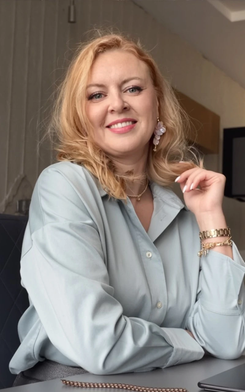 Andrea Florescu, fractional COO, seated at her desk